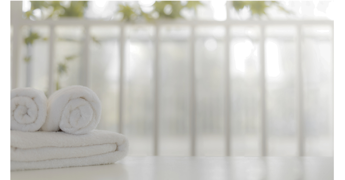 White towels rolled and folded ready for use in a sauna
